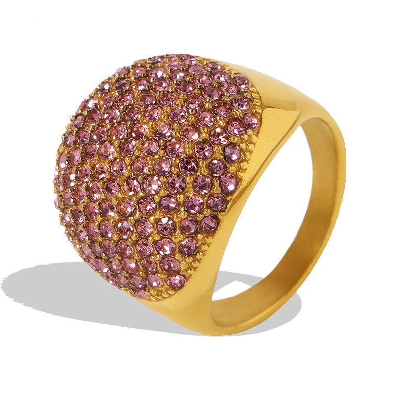 Gold ring with pink gemstones on a white background, featuring the brand 'Liora'.